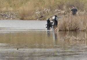 image of man fishing in a shallow water bay for crappies