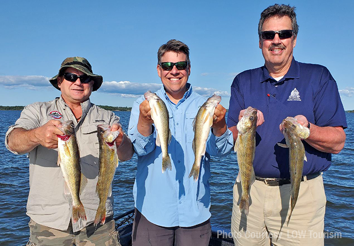 image of men on boat showing off lake of the woods walleyes