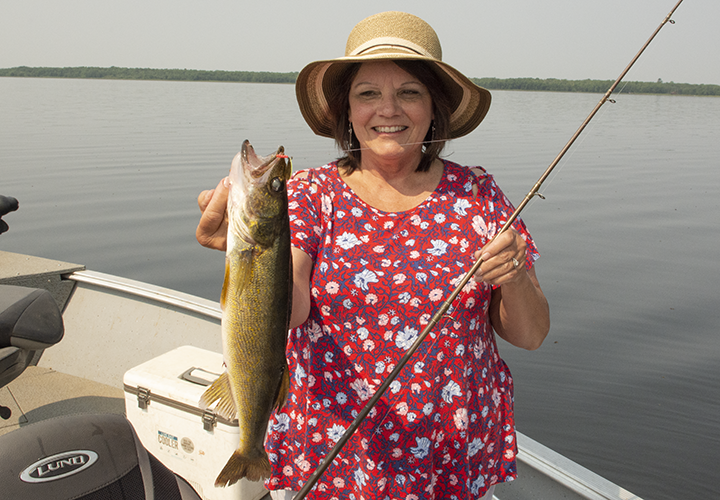 image of The Hippie Chick with nice walleye caught on Bowstring Lake
