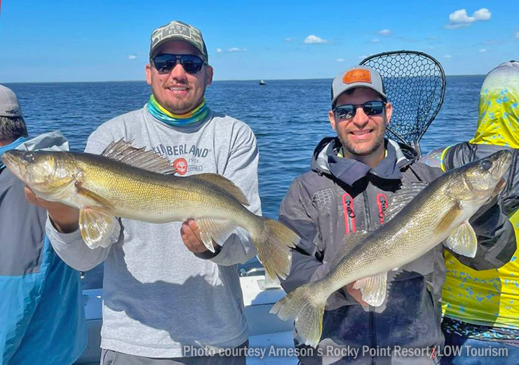 image of 2 men holding big walleyes they caught on lake of the woods