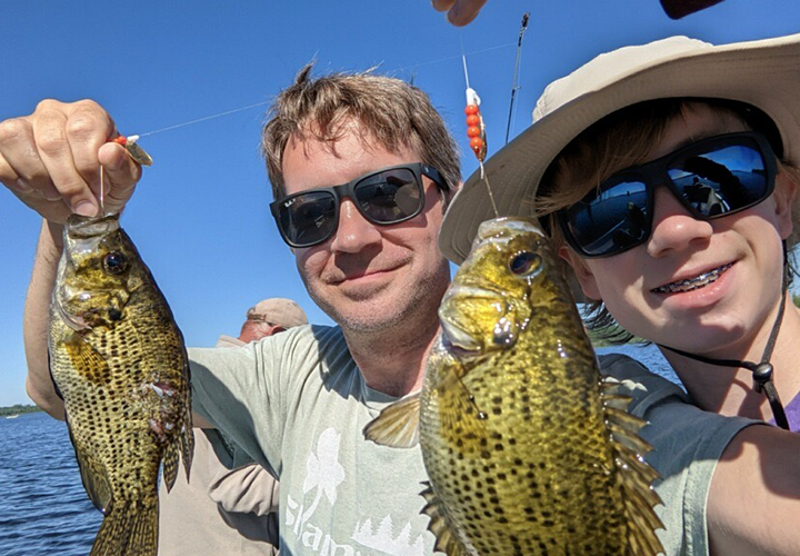 image of sean and finn dunnigan holding rock bass