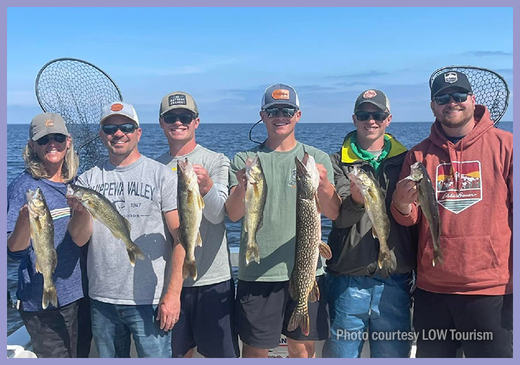 image of 6 person fishing party showing their catch after lake of the woods charter trip