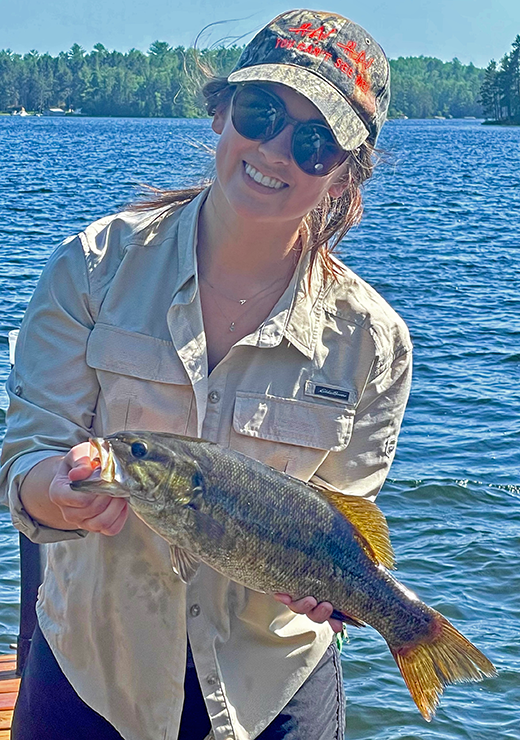 image of woman holding a nice smallmouth bass