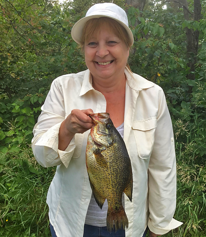 image of woman with huge crappie caught near Ely MN