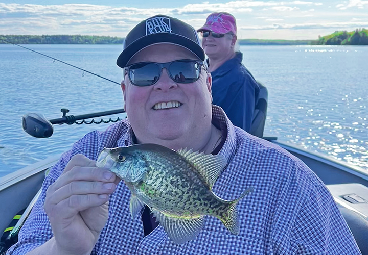 image of Gary Sundin holding crappie caught oin Portage Lake