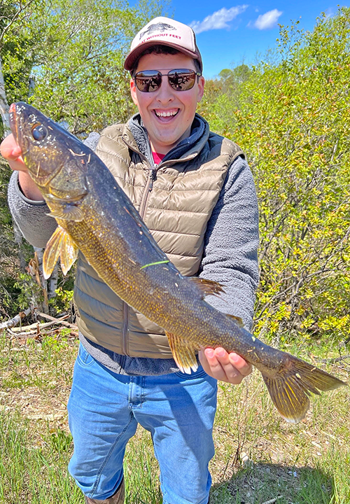 image of walleye fisherman holding large fish he caught near Ely Minnesota