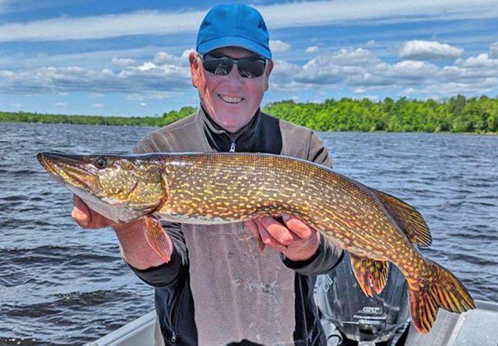 image of Grand Rapids fishing guide Jeff Sundin holding large northern pike caught on a Remer MN area lake