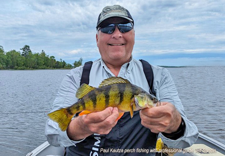 image of Paul Kautza holding jumbo perch caught on a fishing trip with pro guide Jeff Sundin 