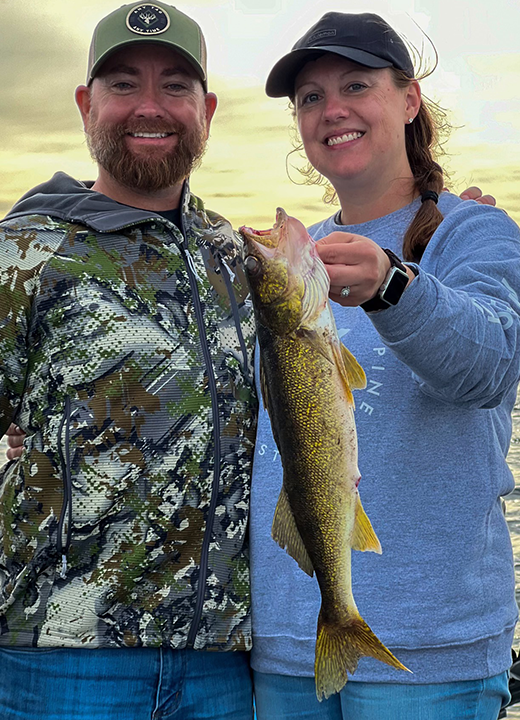 image of woman holding nice walleye she caught on a fishing charter with Joe Billiar