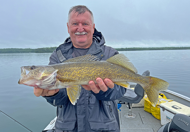 image of Bobby Cox holding nice walleye he caught oin fishing trip with pro guide Jeff sundin