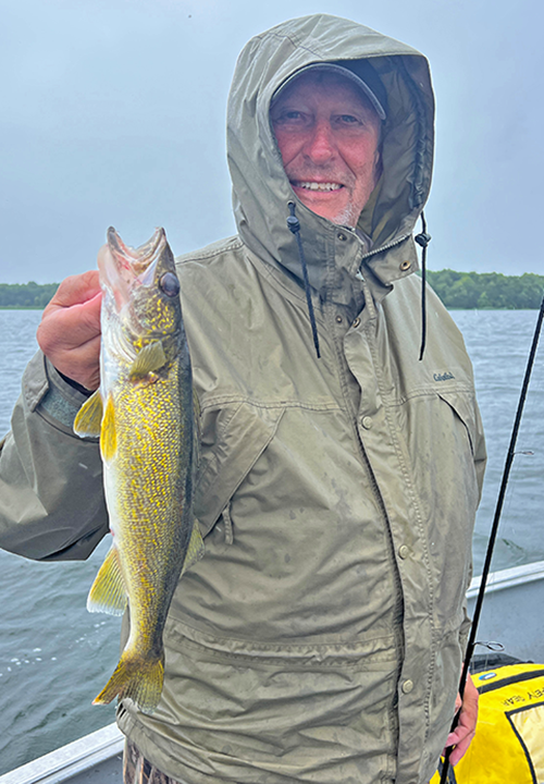 image of Spencer Schram with lake winnie walleye