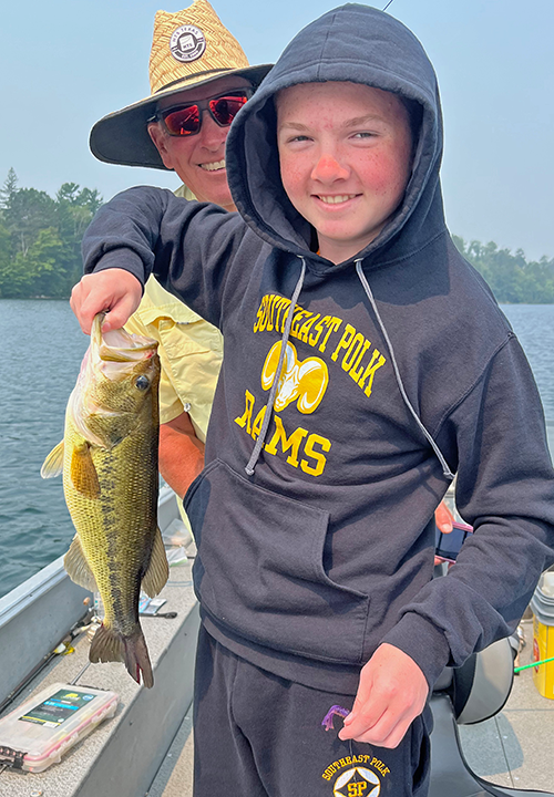 image of Landry Patterson with nice largemouth bass caught on fishing charter with Jeff Sundin