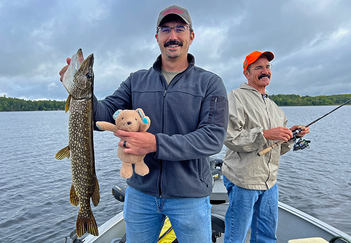 image of Ryan Clevenger holding large northern pike caught on fishing charter with jeff Sundin 