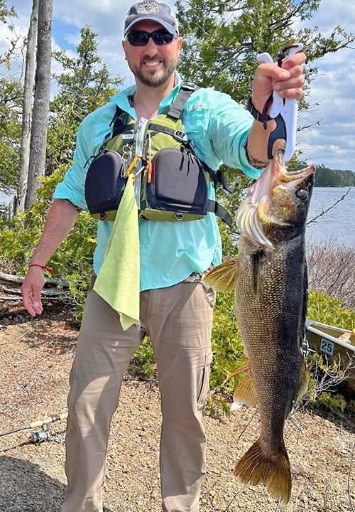 image of camper on canoe trip near Ely holding a large walleye 