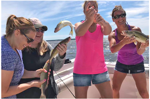 image of 4 women holding walleyes