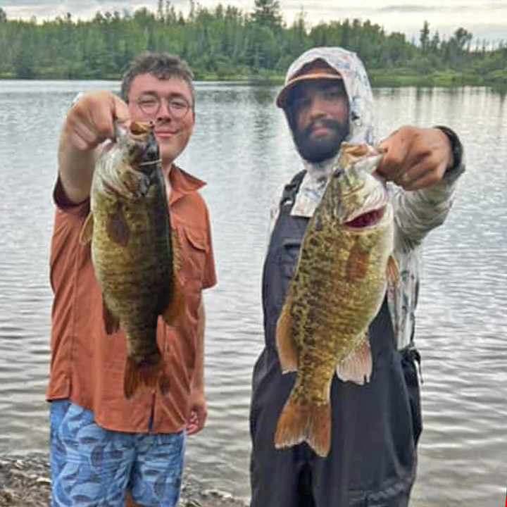 image of 2 fishermen with big smallmouth bass caught near Ely Minnesota
