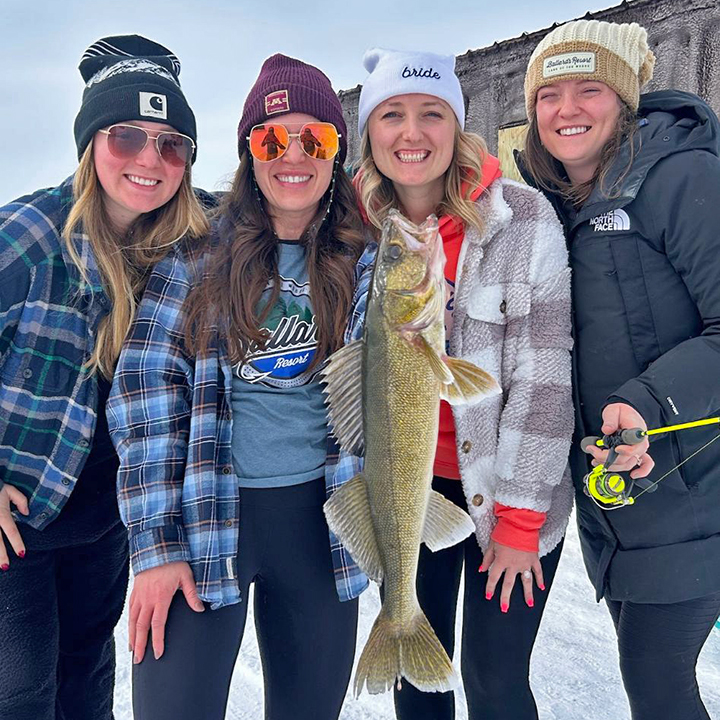 image of women's ice fishing party and a big walleye caught on Lake of the Woods