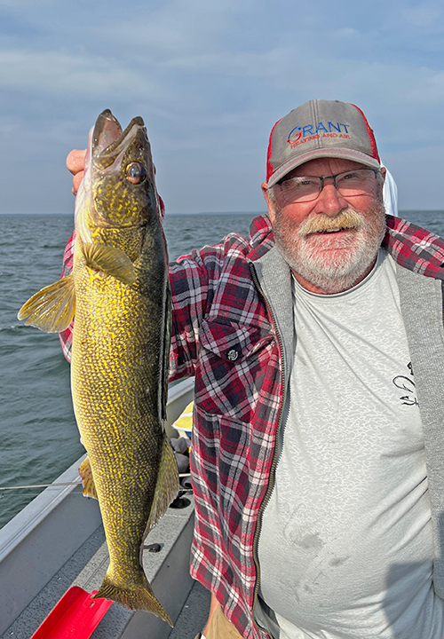 image of Mike Cooley holding big Lake Winnie walleye