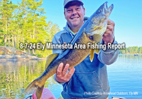 image of man holdiung big walleye he causght while fishing newar Ely MN