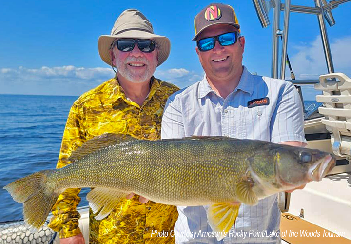 image of anglers showing off huge walleye caught on Lake of the Woods