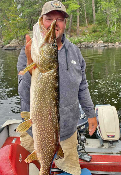 image of angler holding huge northern pike he caught in the Ely Minnewota Area