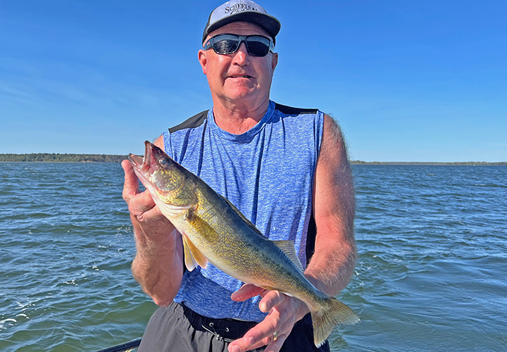 image of Dana holding nice walleye caught on Lake Winnie