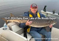 image of man holding big sturgeon caught on the rainy river