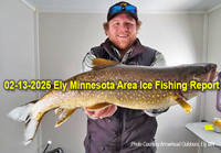 image of ice fisherman holding big lake trout he caught near Ely Minnesota