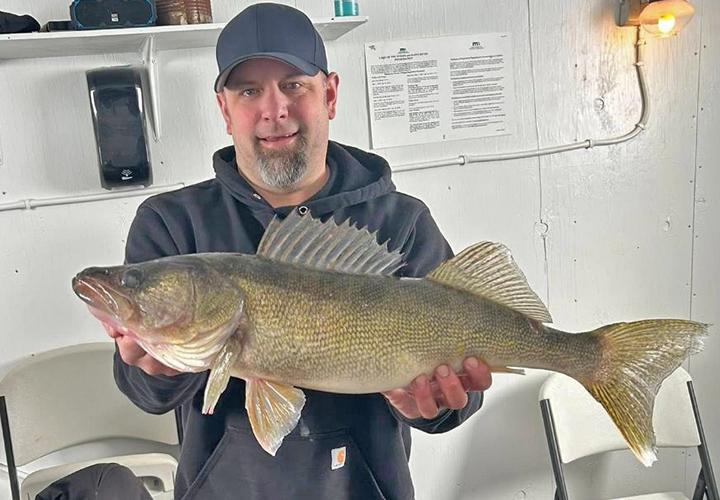 image of ice fisherman who cught a huge walleye at Ken Mar Ke resort on Lake of the Woods