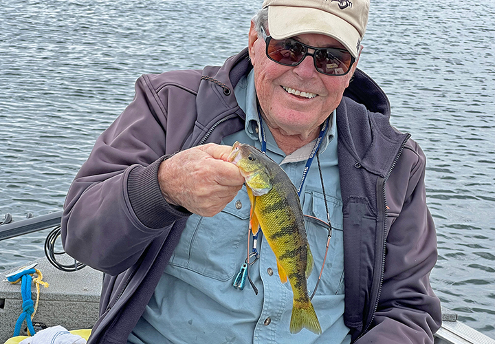 image of Dick Williams holding a jumbo perch caught on fishing charter with Jeff Sundin 