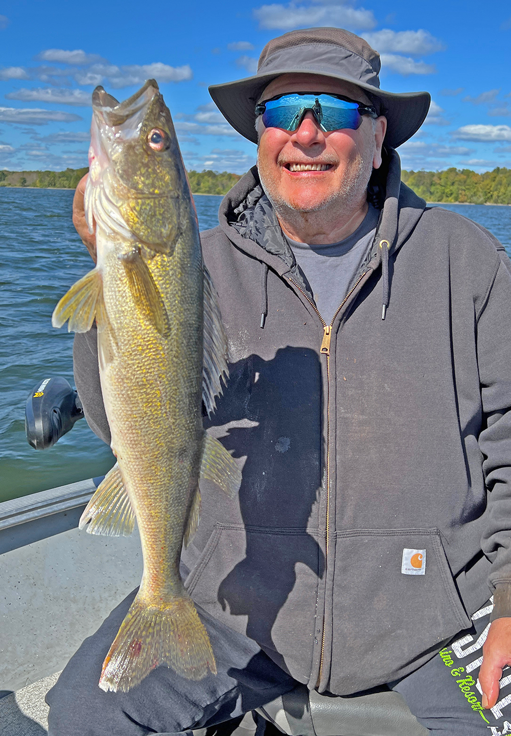 image of Kyle Reynolds with big walleye caught on lake Winnibigoshish