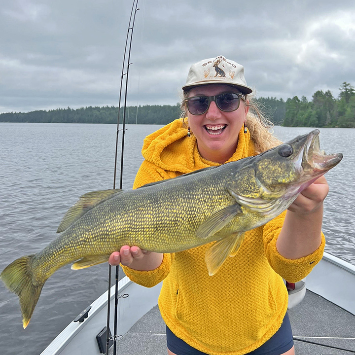 image of woman holding big walleye she caught near Ely Minnesota