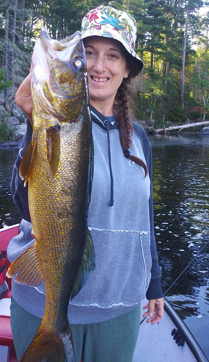 image of woman holding huge walleye caught in the Ely Minnesota region