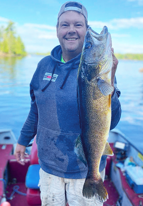 image of fisherman with big walleye caught near Ely Minnesota