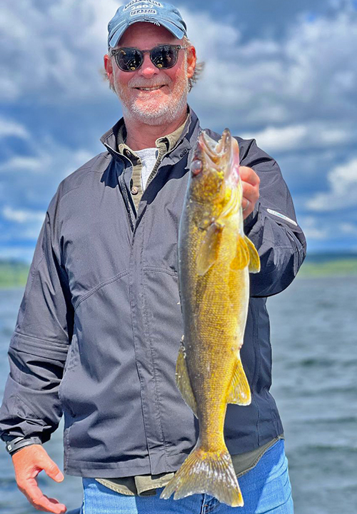 image of angler holding big walleye caught on a fishing charter with Joe Billiar